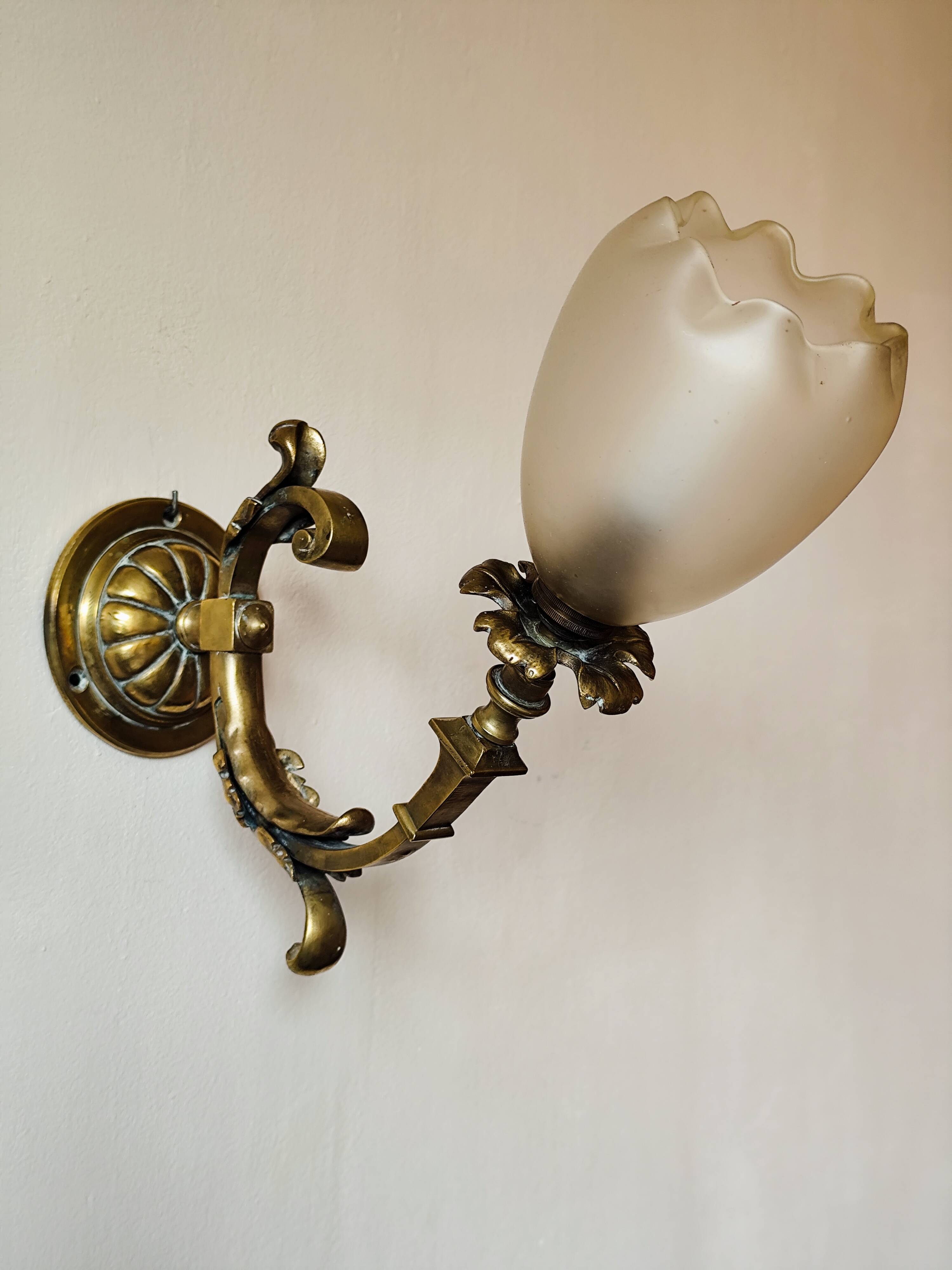 Bronze wall light with opaque glass tulip