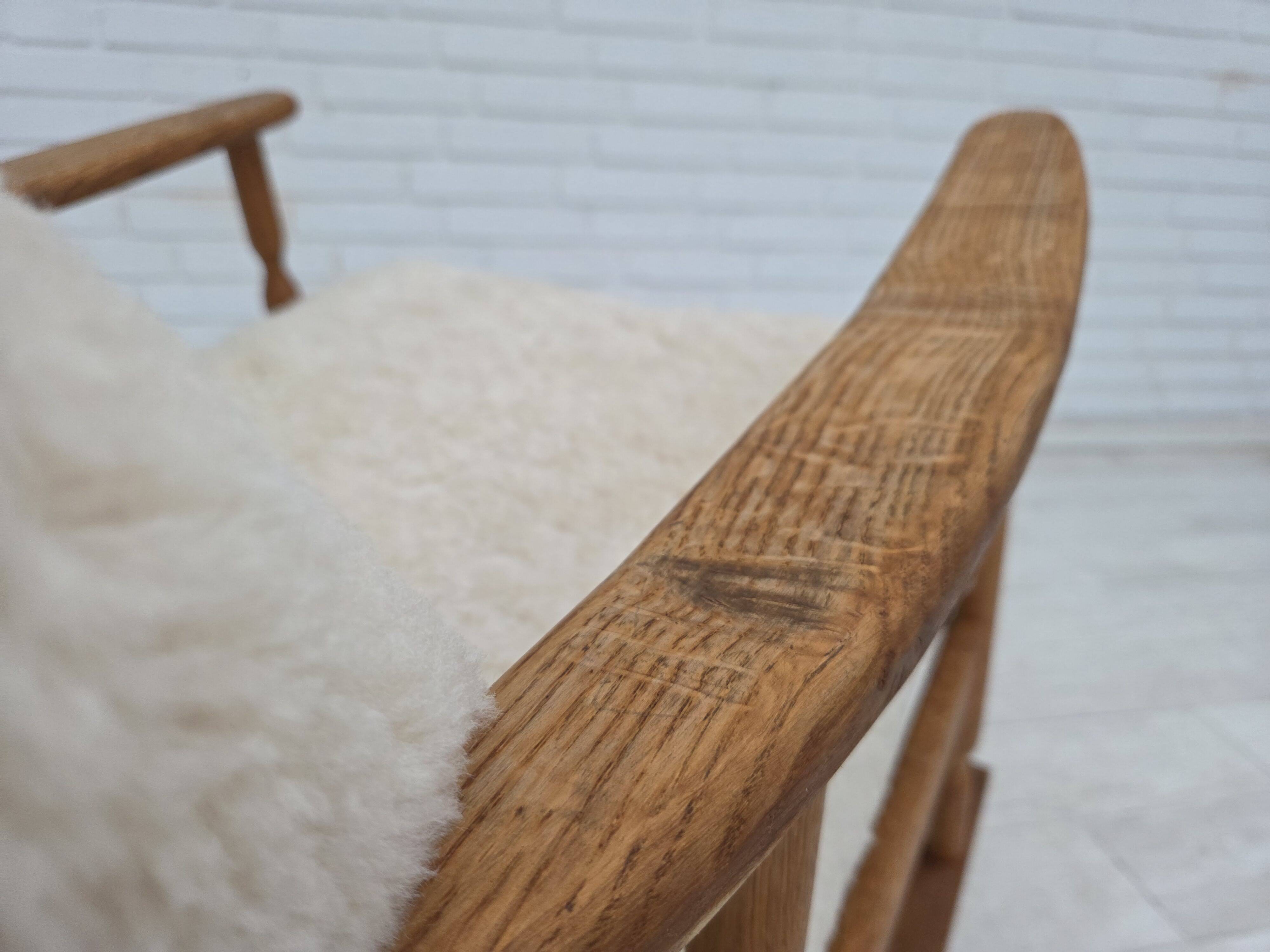 1970s, Danish rocking chair, reupholstered in quality genuine sheepskin.