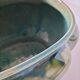 Art Deco flared cache-pot in turquoise glazed earthenware.