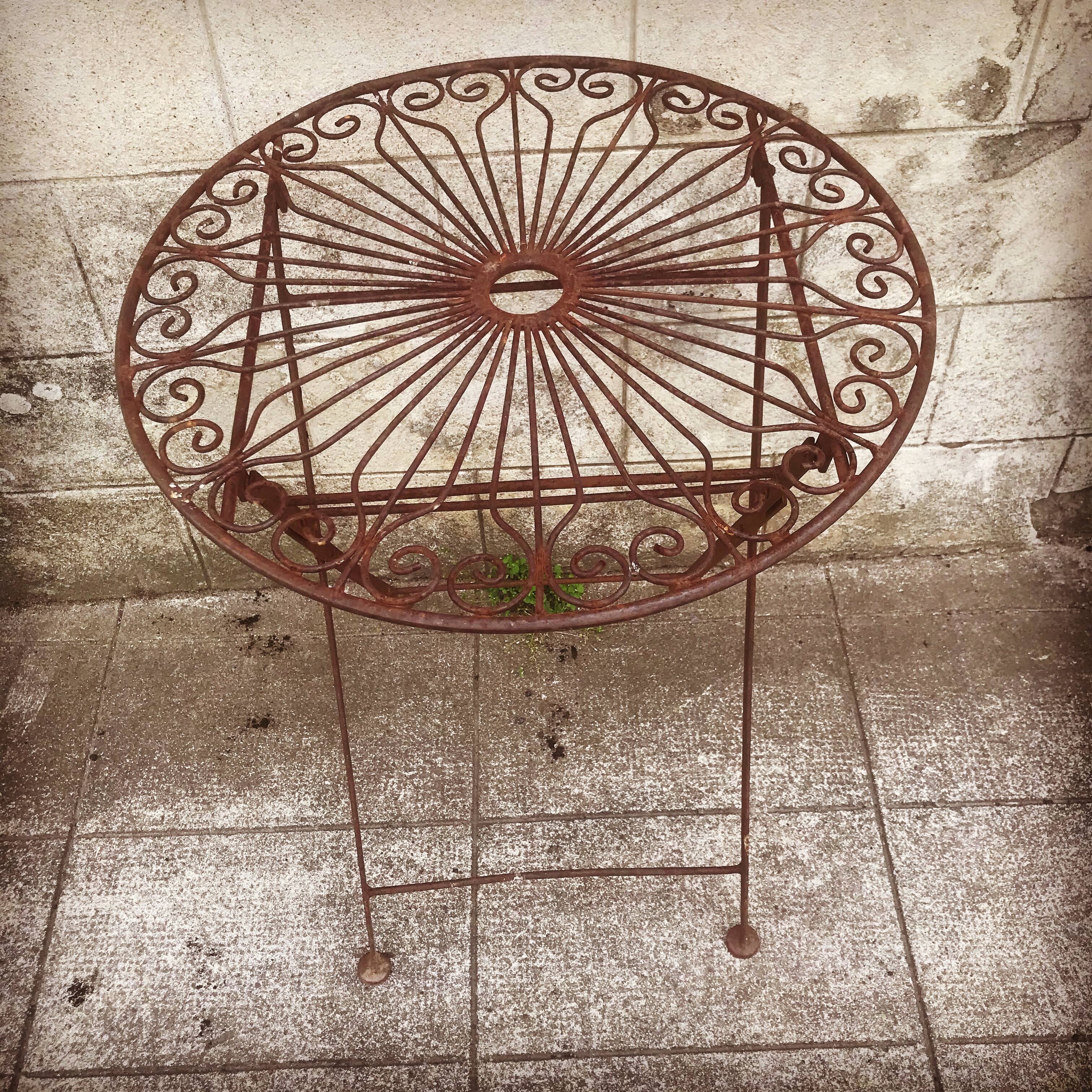 Ancient wrought iron pedestal table