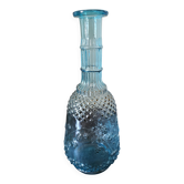 Small vintage turquoise blue glass carafe with floral design.