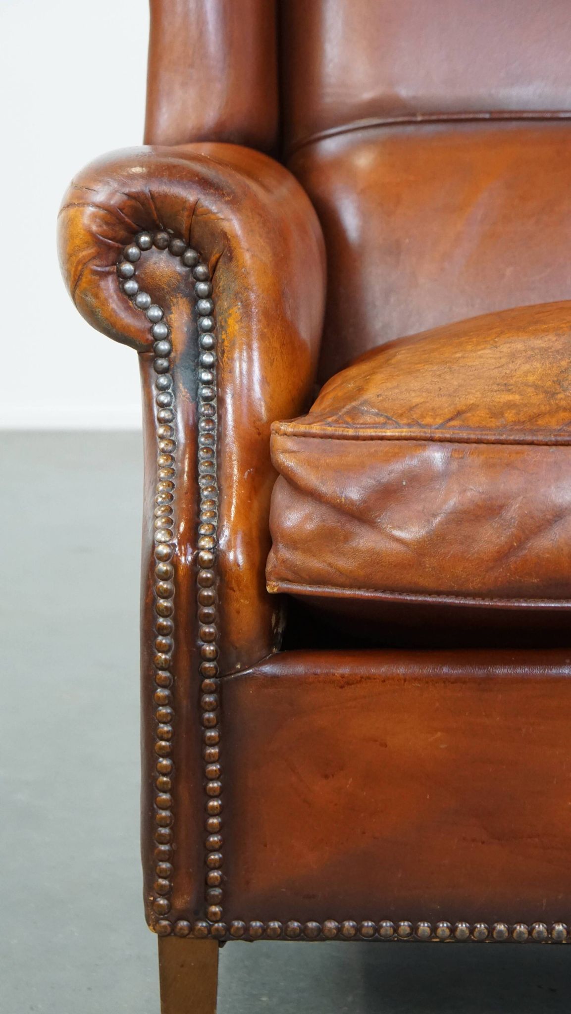 Sheepskin leather wingback chair with patina