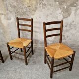 4 wooden and straw chairs