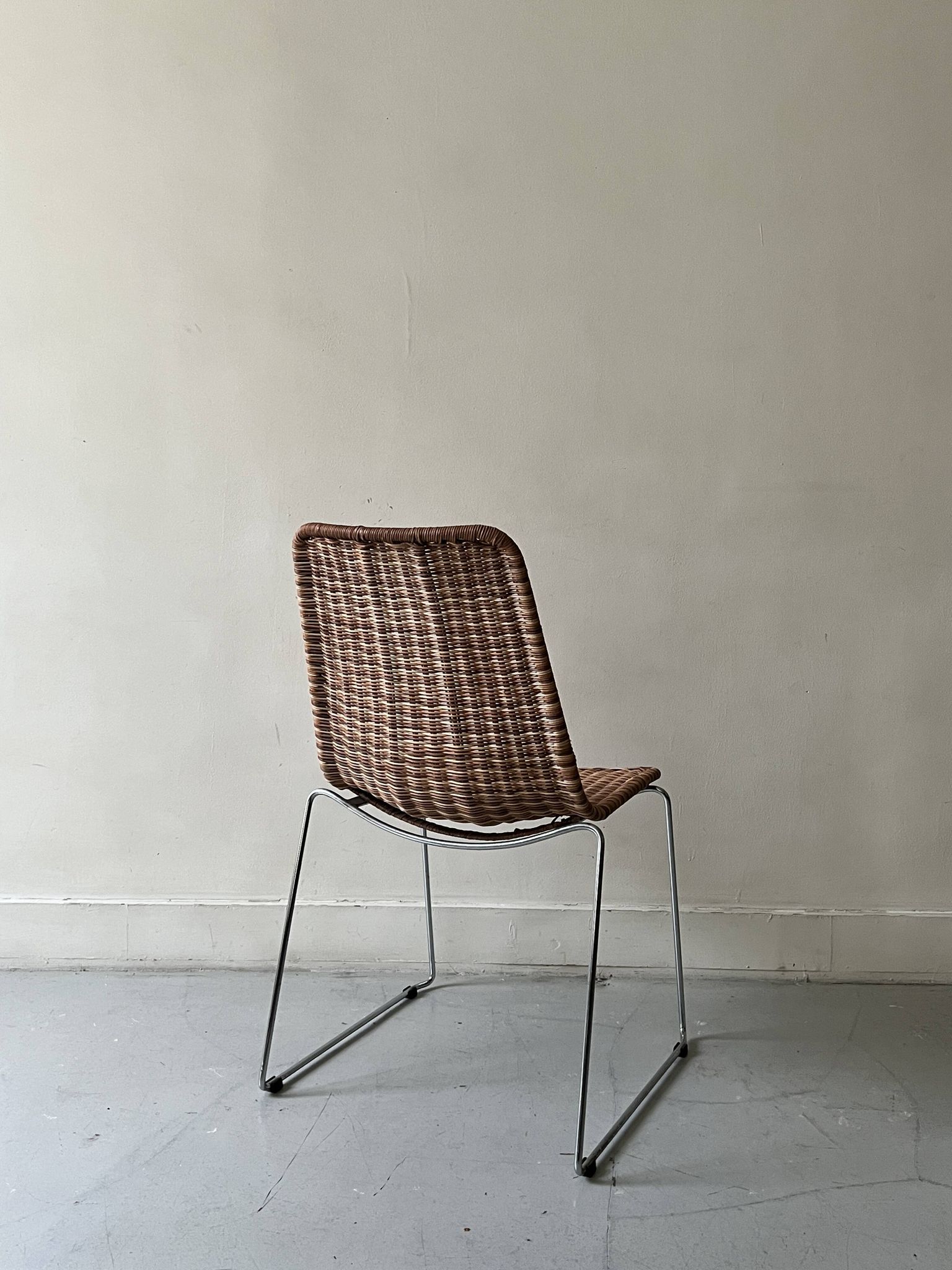 Chair design in rattan, woven wicker and chrome wire metal.