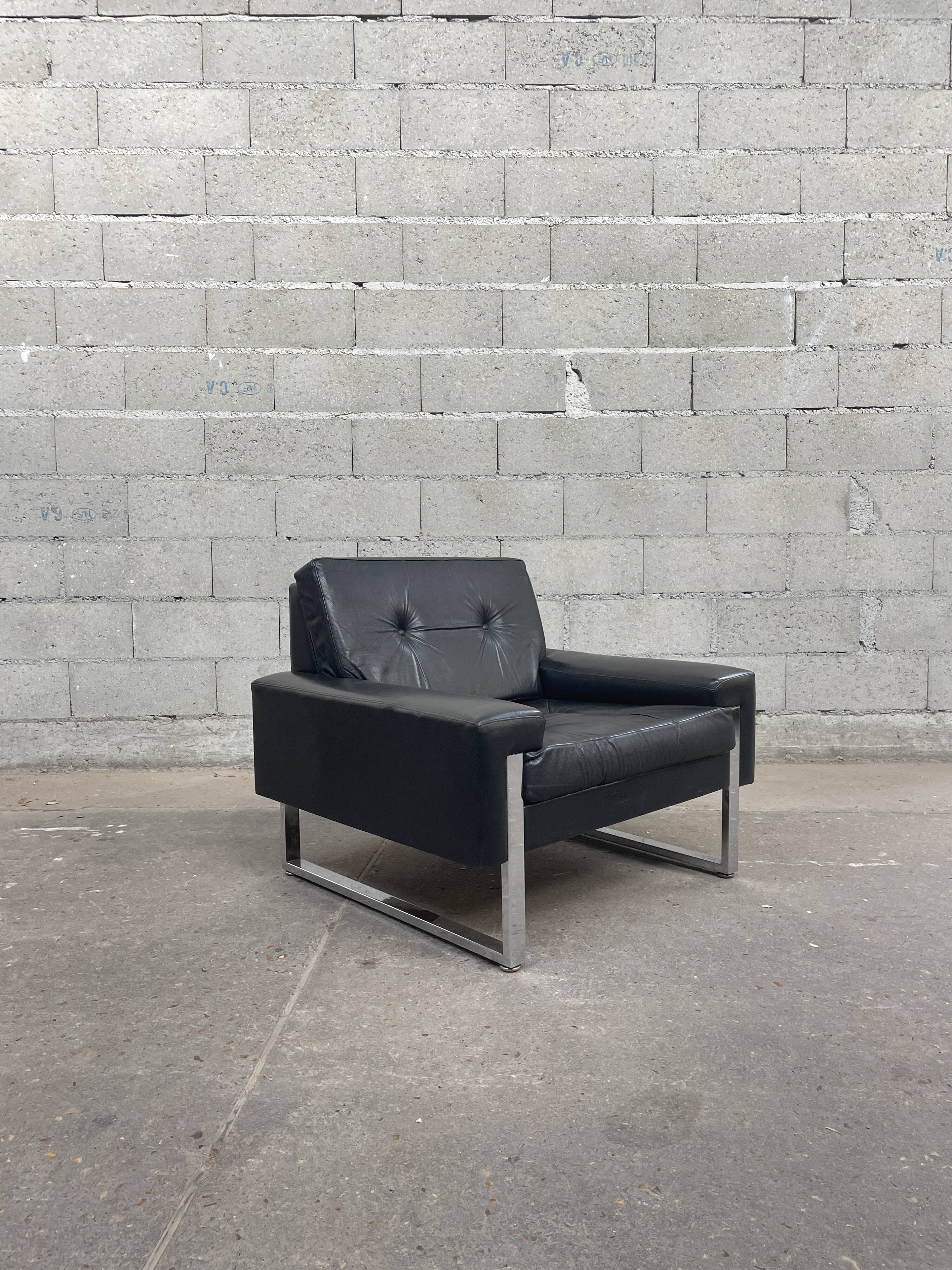 Pair of black leather armchairs
