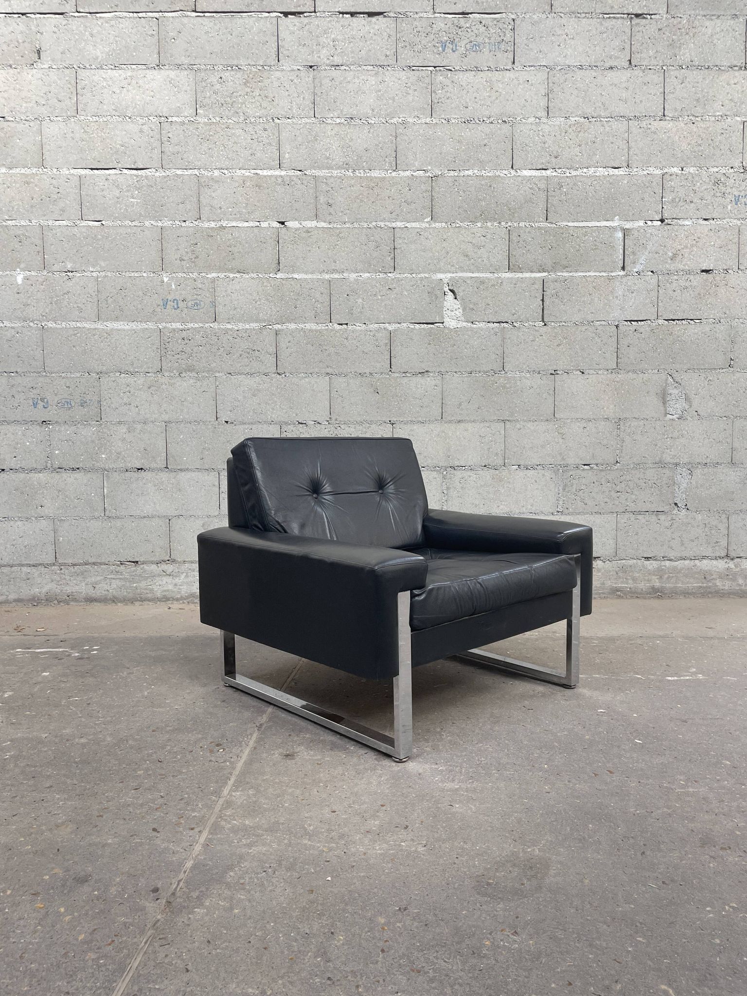 Pair of black leather armchairs