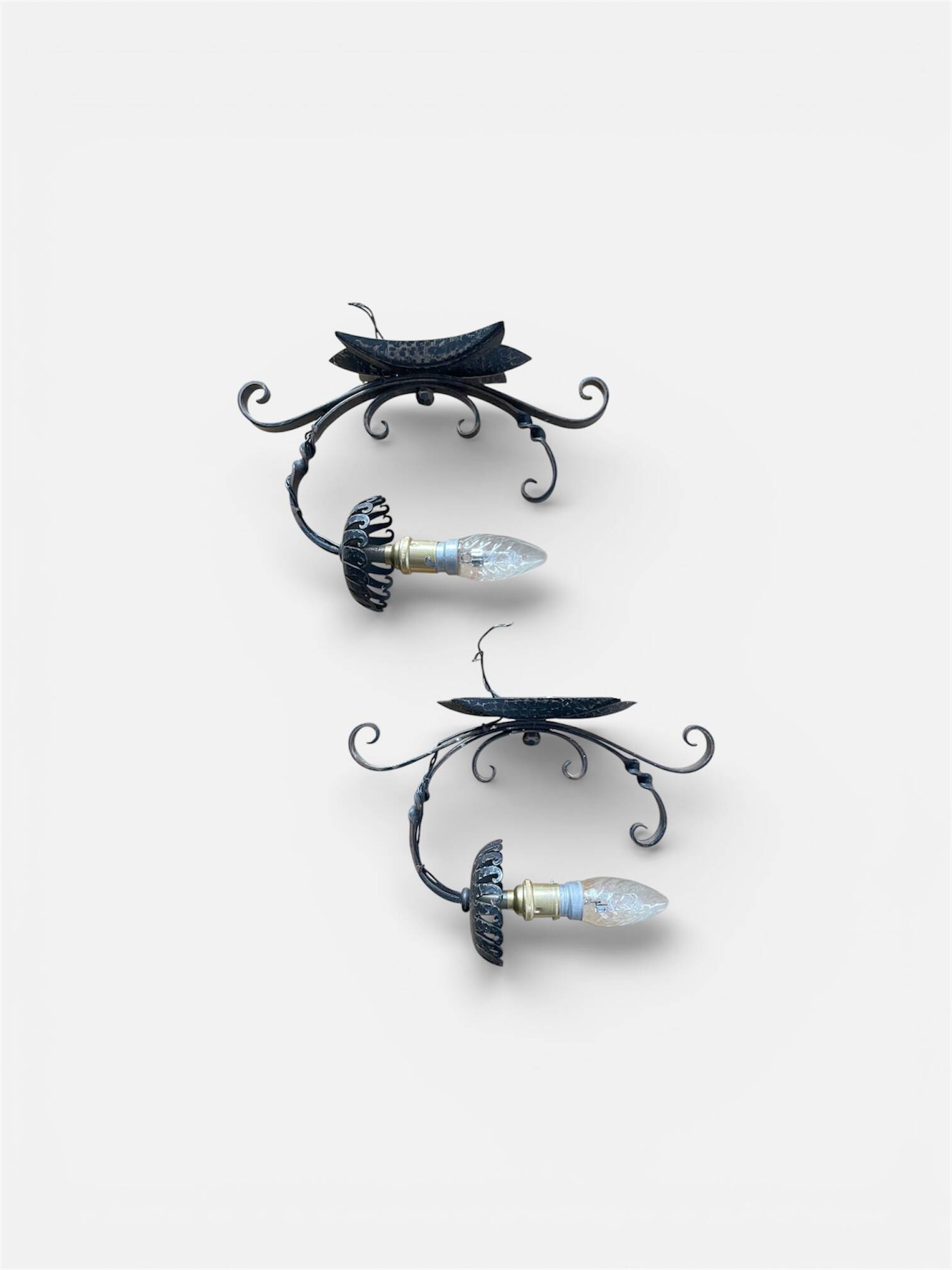 Vintage wrought iron wall lights in rustic gothic style.