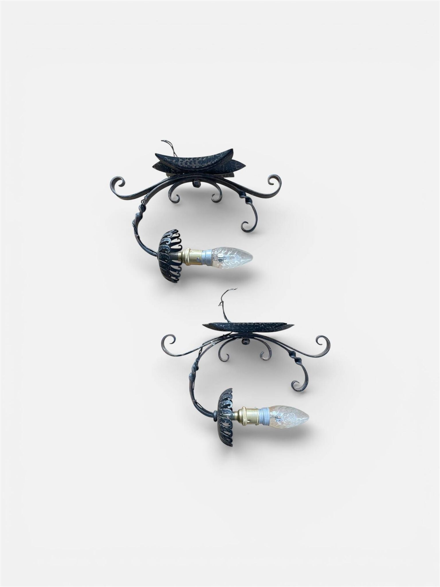 Vintage wrought iron wall lights in rustic gothic style.