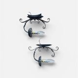 Vintage wrought iron wall lights in rustic gothic style.