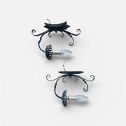 Vintage wrought iron wall lights in rustic gothic style.