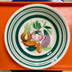 Vintage deep plate with vegetable decoration.
