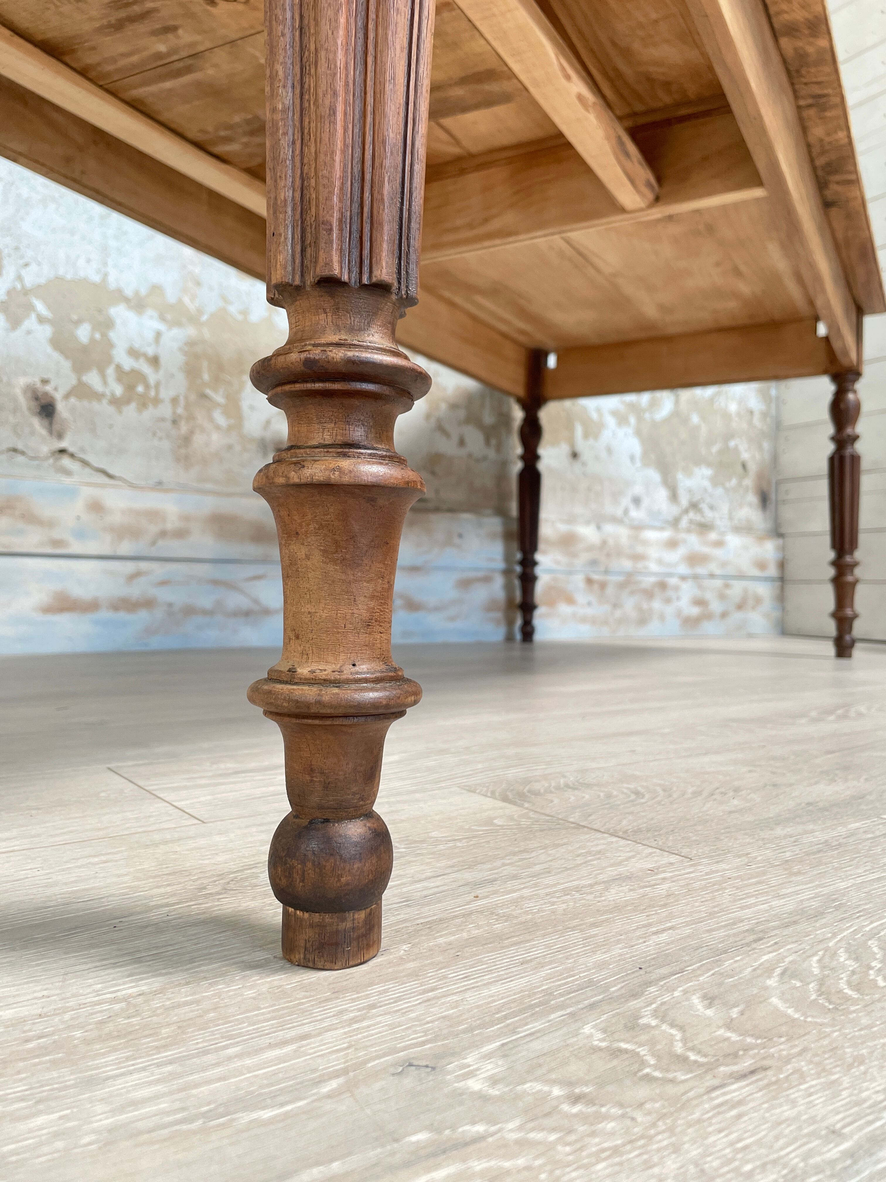 Vintage farmhouse table with turned legs.