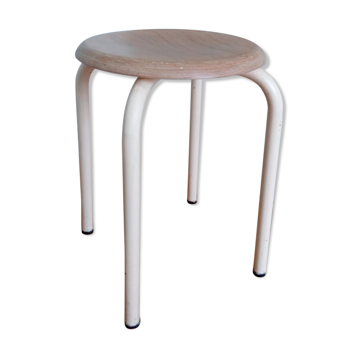 Industrial tubular metal stick sitting round in wood