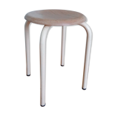 Industrial tubular metal stick sitting round in wood