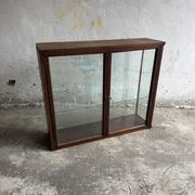 Dark-stained wood and glass vintage display cabinet — early 20th-century wall-mounted showcase