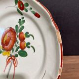 Easternth century earthenware plate, ribboned floral decoration