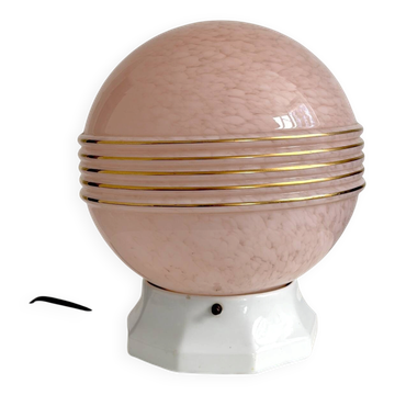 Art Deco lamp with a speckled pink glass globe and a white ceramic base.