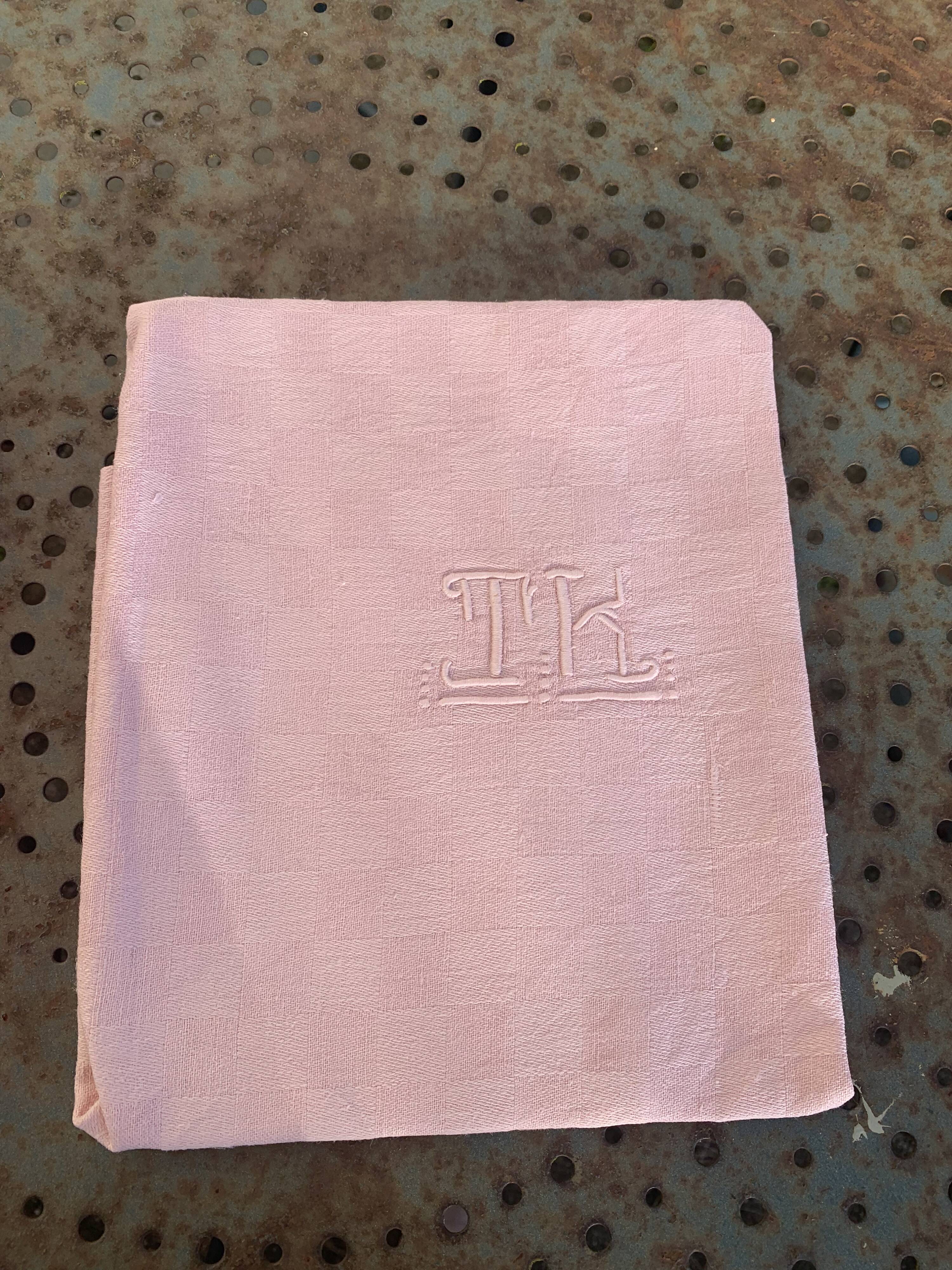 Duo set, consisting of two large pink-dyed cotton and linen towels, embroidered, TK monograms