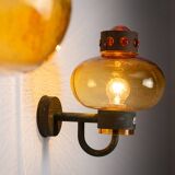 Pair of brass wall lamps with decorated amber coloured shades