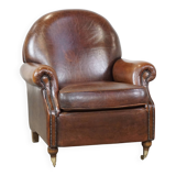 Sheep leather armchair on wheels
