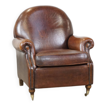 Sheep leather armchair on wheels