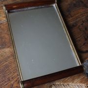 Rectangular mirror tray with wooden handles and gilding.