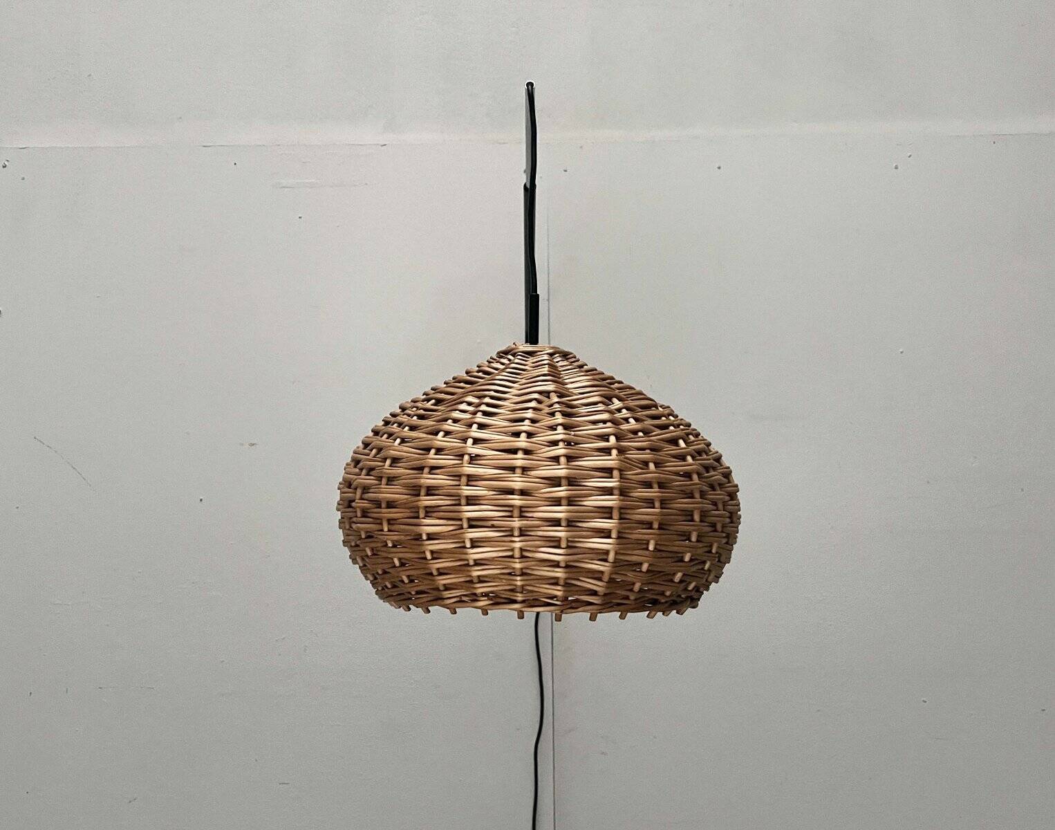 Mid-century modern Danish extendable cantilever wall lamp with a rattan shade, 1960s.
