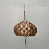 Mid-century modern Danish extendable cantilever wall lamp with a rattan shade, 1960s.