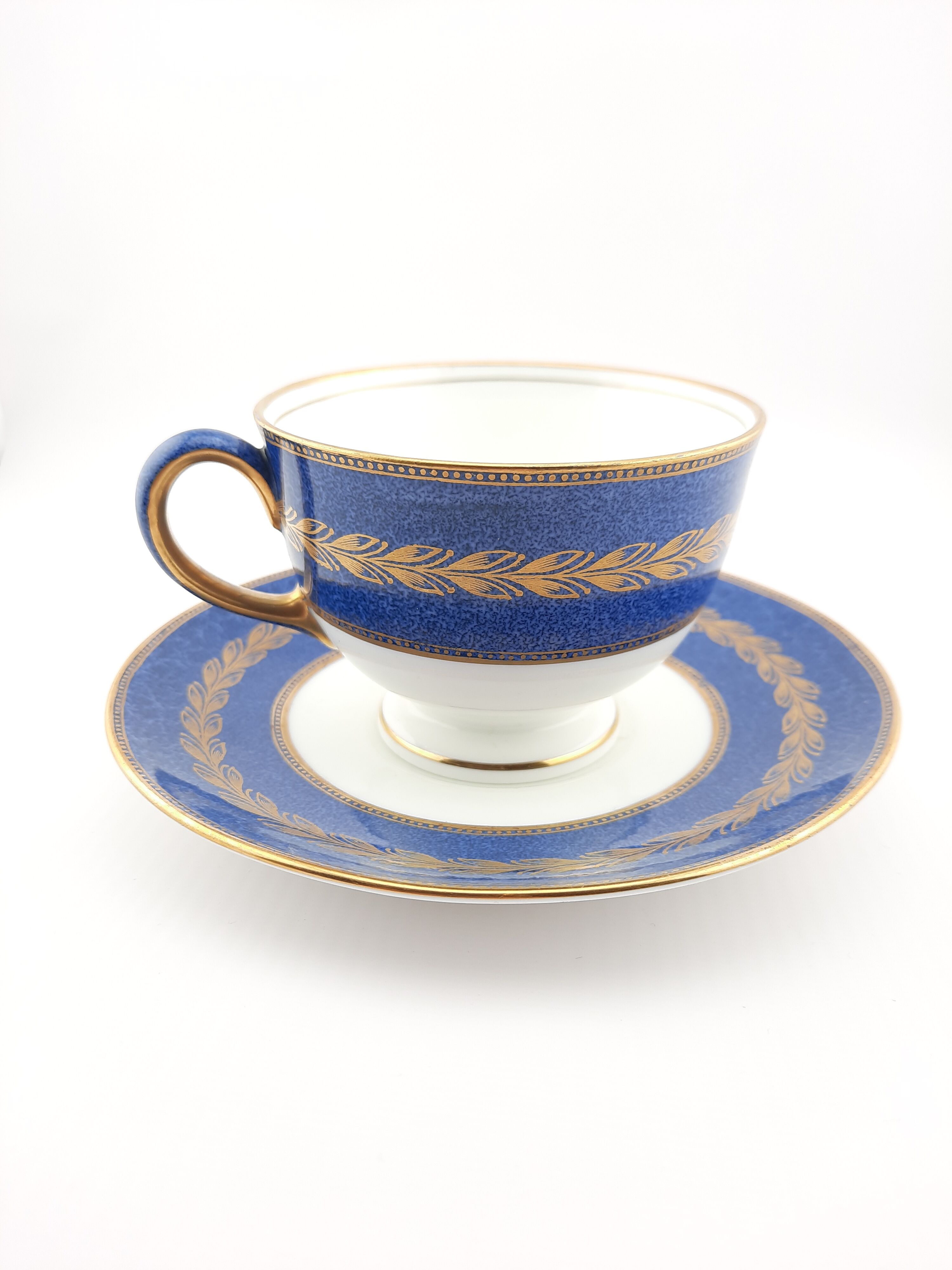 Antique Wedgwood teacup and saucer, bone china. Powder blue and gold English footed cup and saucer,