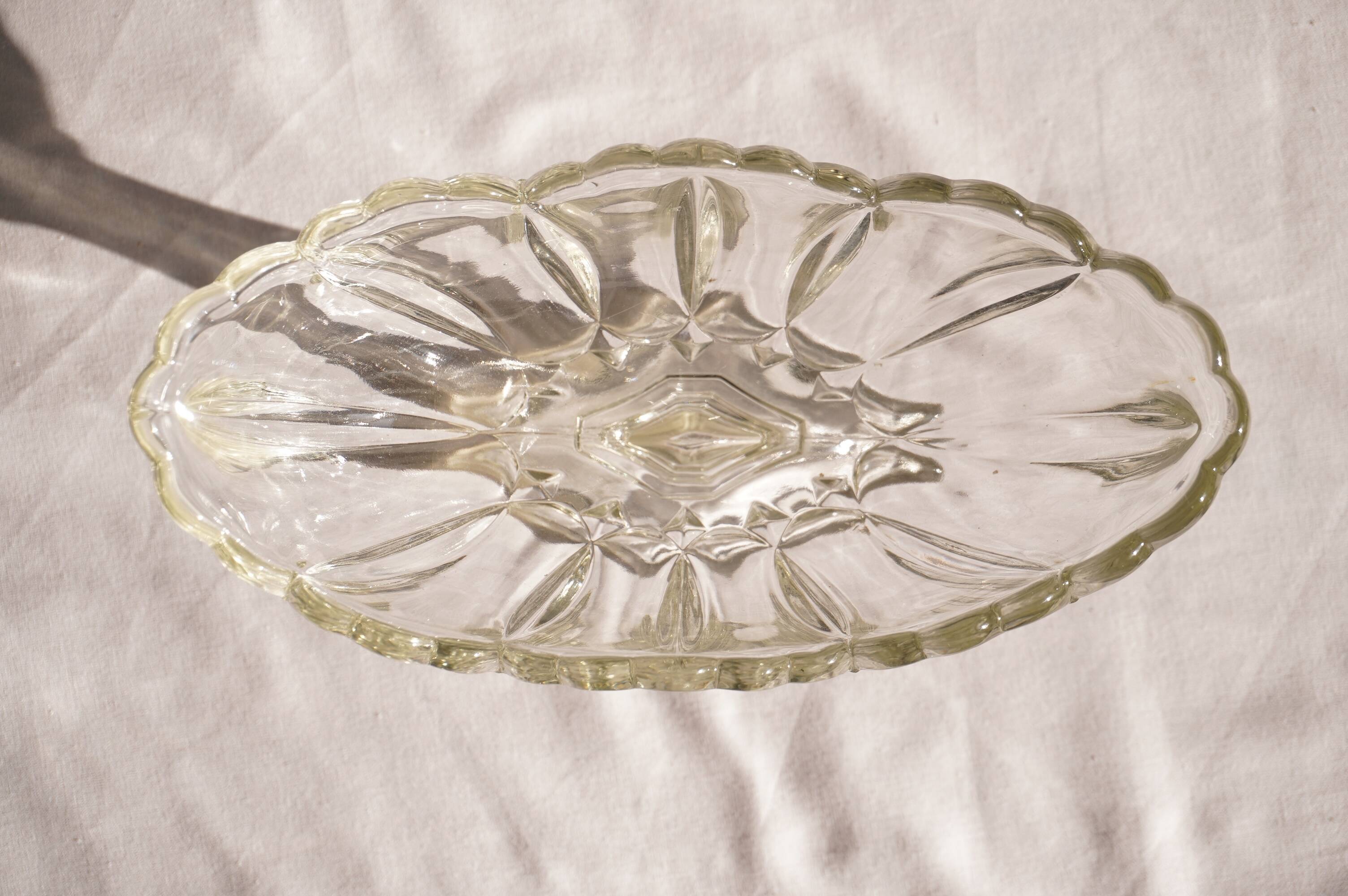 Oval glass fruit bowl on a stand.