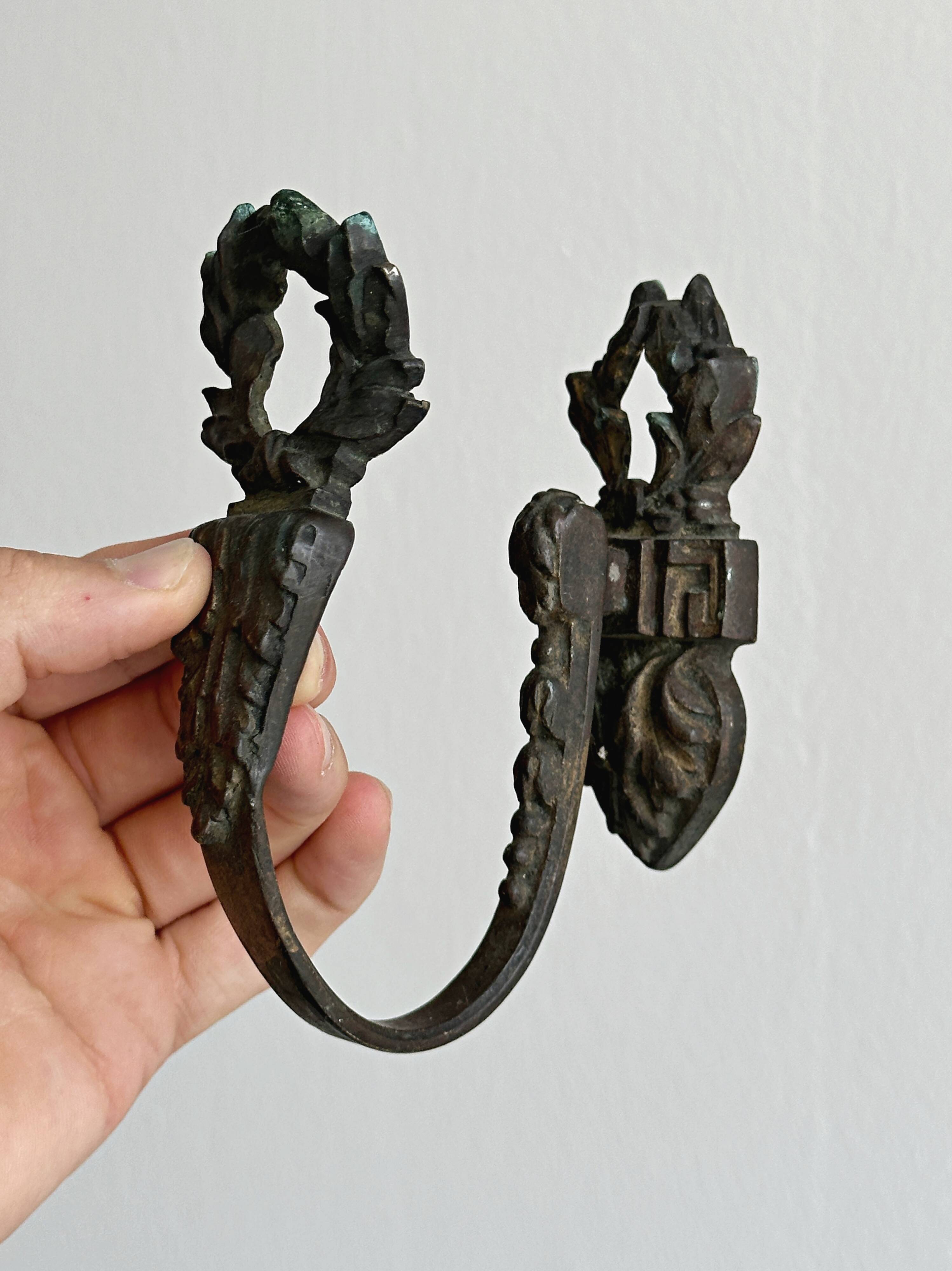 Antique black patinated metal coat hook.