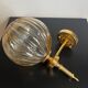 Brass wall light and bubbled glass globe