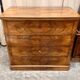 Antique English commode in flame walnut.