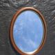 Old oval mirror, walnut wood tower, gilded border