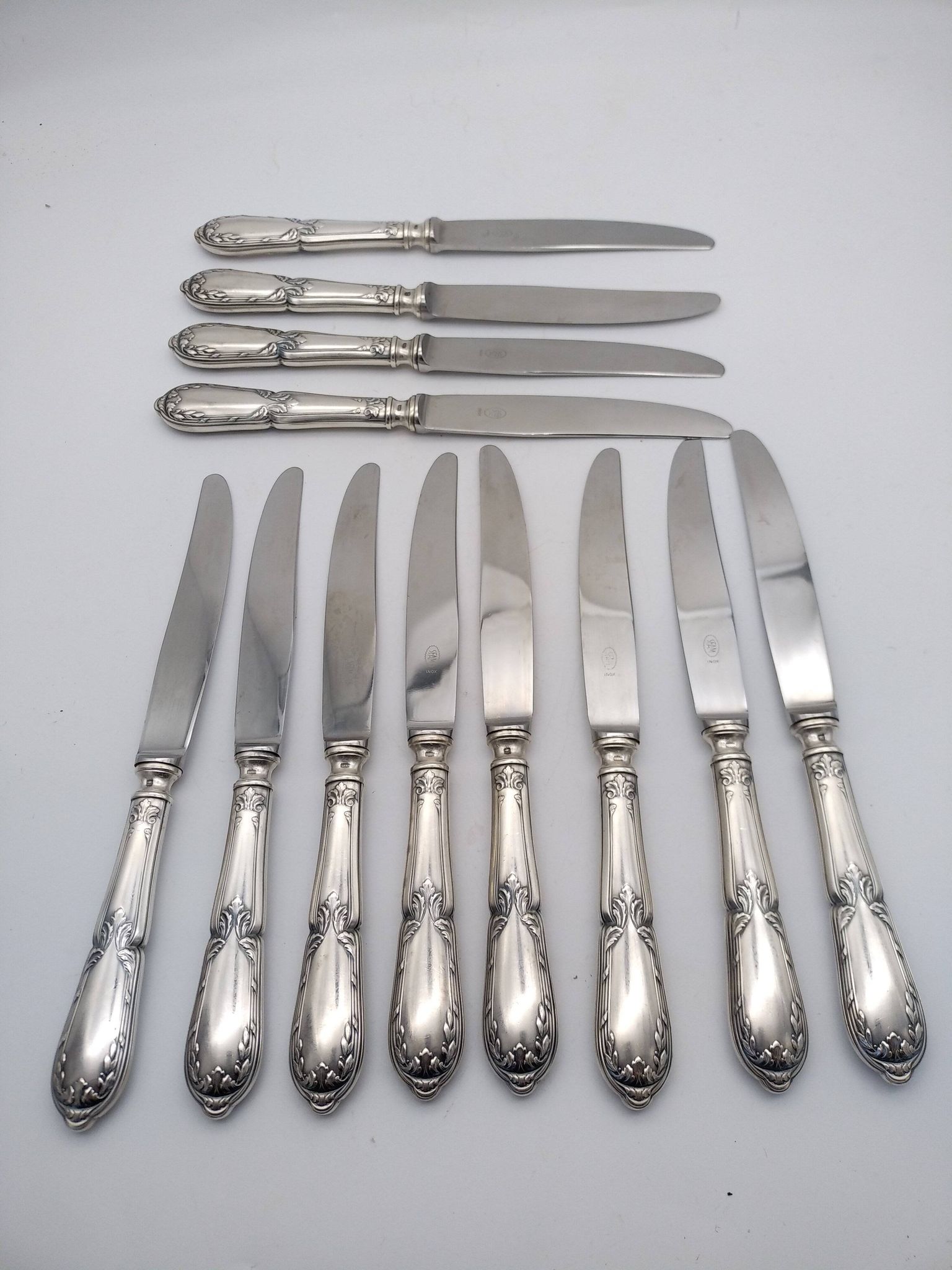 Set of 12 sfam knives in silver metal and stainless steel blades.