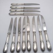Set of 12 sfam knives in silver metal and stainless steel blades.
