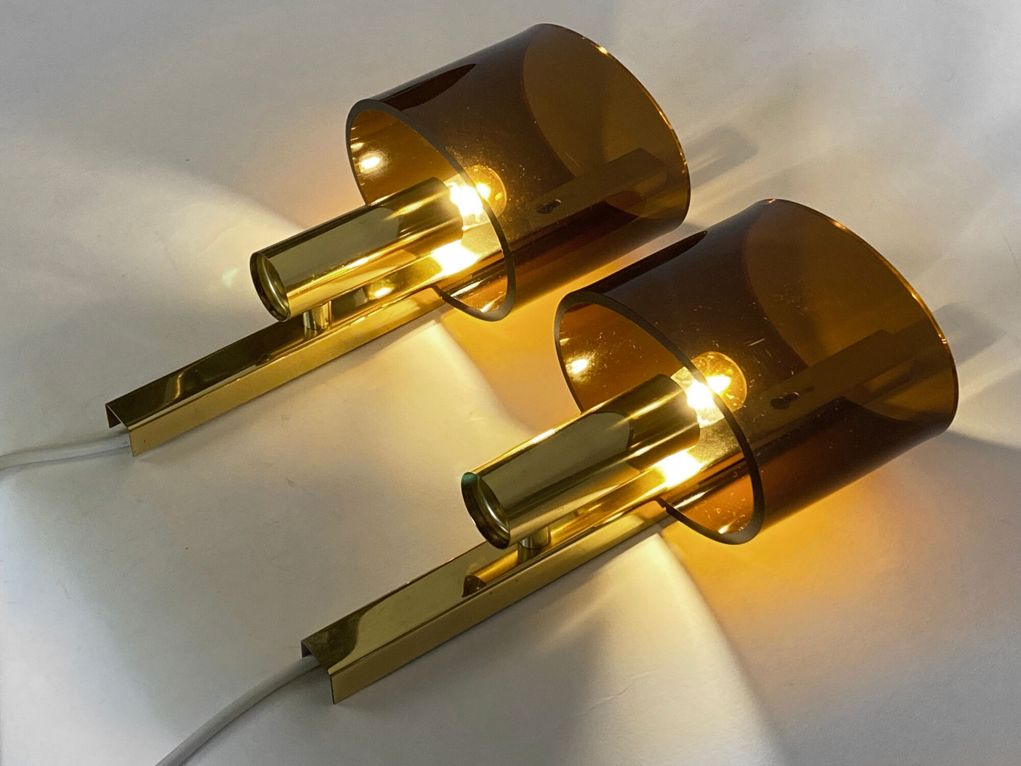 Pair of brass sconces with toned plastic shades, Denmark 1970s