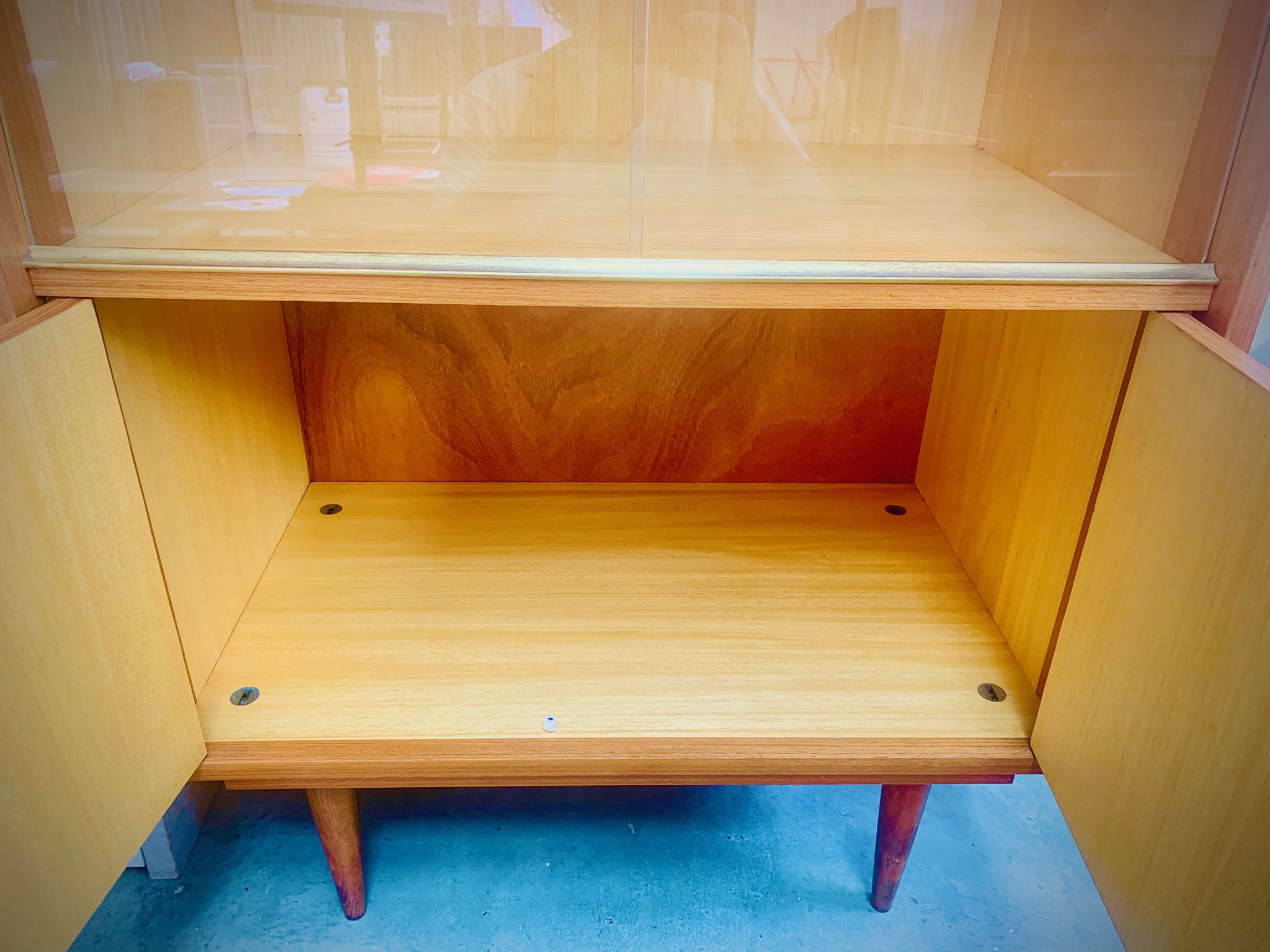 Double display case mounted at an angle with doors from the Capelle 60' house in Montauban