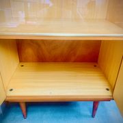 Double display case mounted at an angle with doors from the Capelle 60' house in Montauban