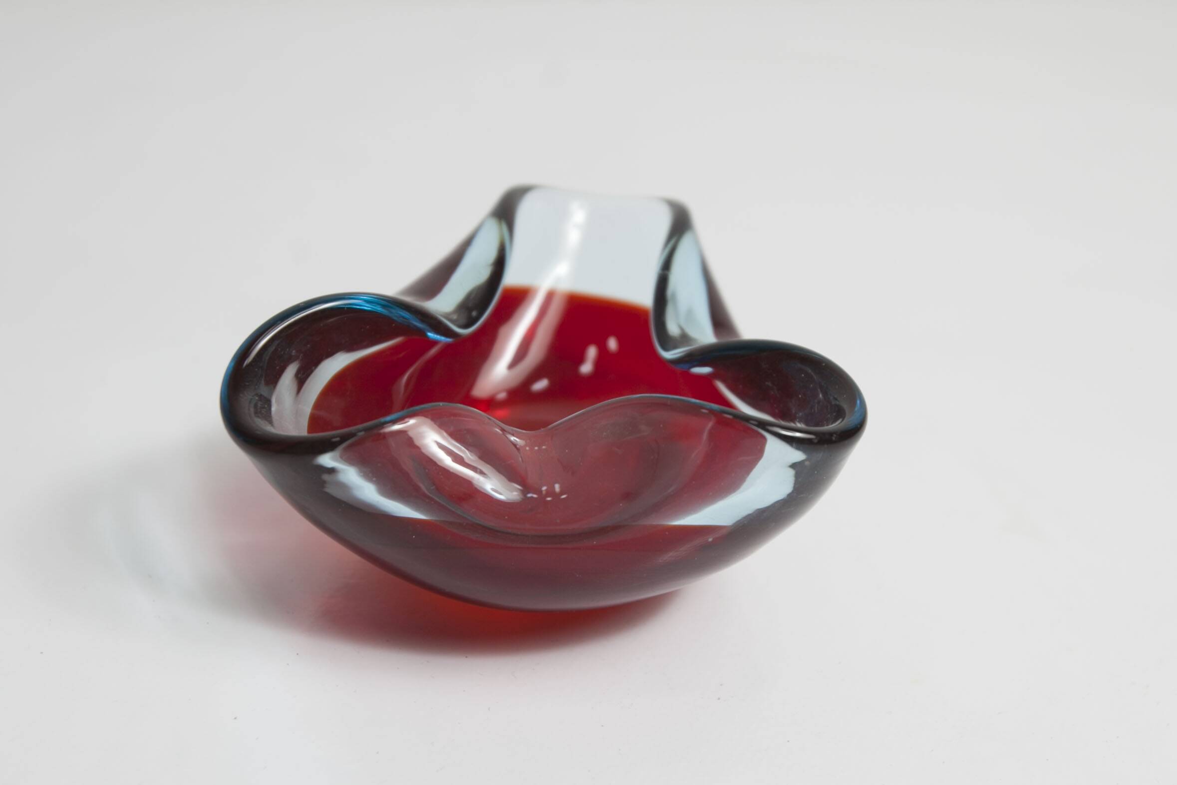Asymmetrical ashtray murano red and transparent background 1960