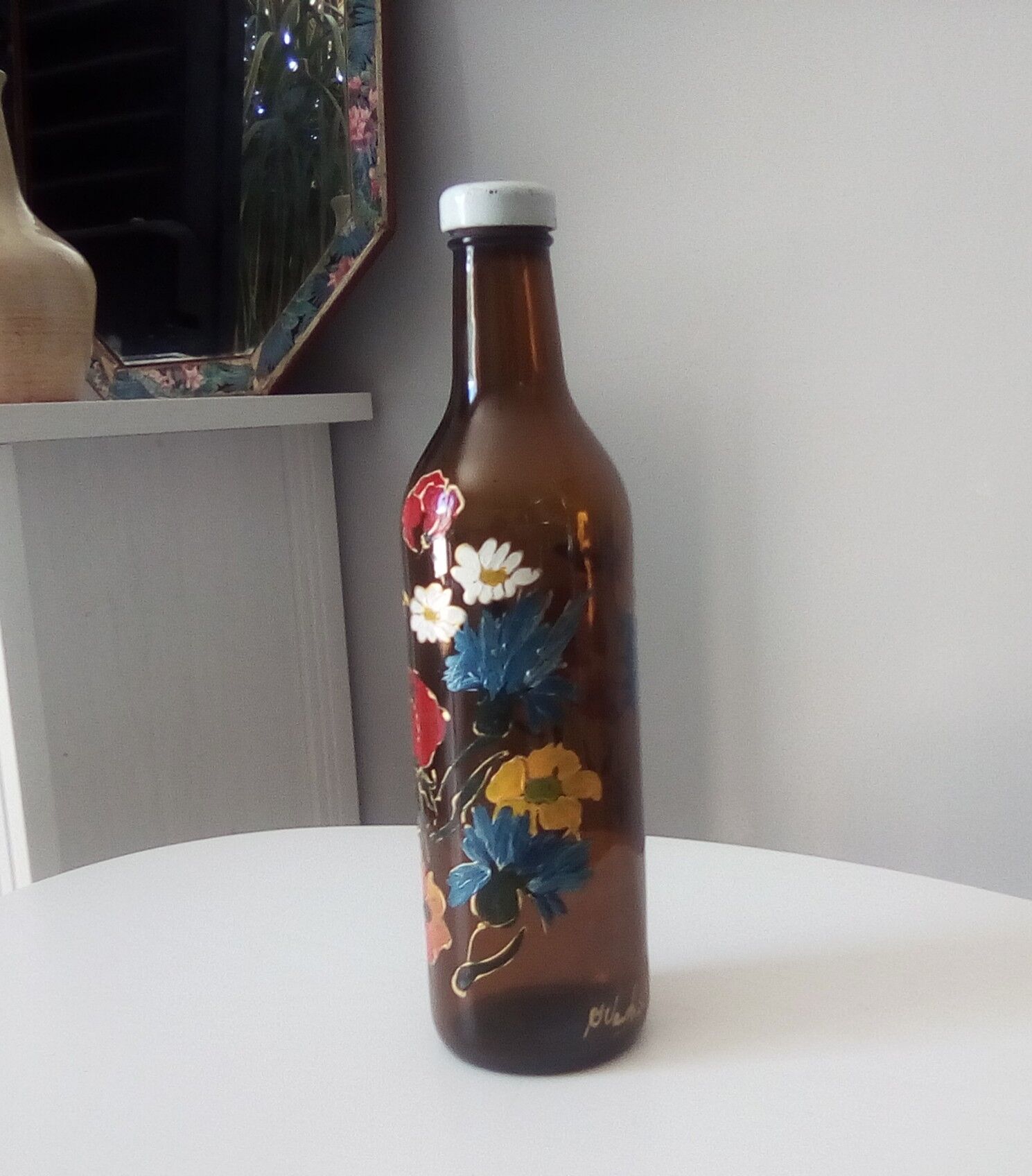 Vintage hand-painted amber glass bottle