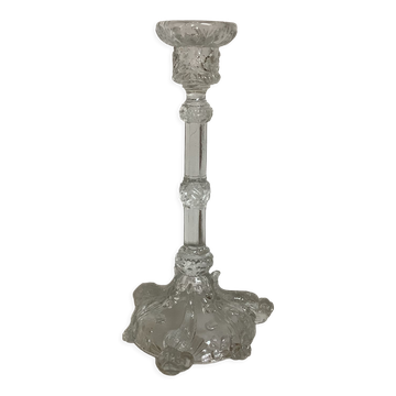 Thick moulded glass candlestick with fish and flowers.