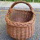 Round oval basket in rattan and woven wicker with handle