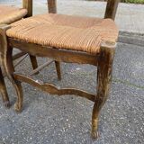 2 solid oak carved and rush-seated chairs in the Louis XV style from the 19th century.