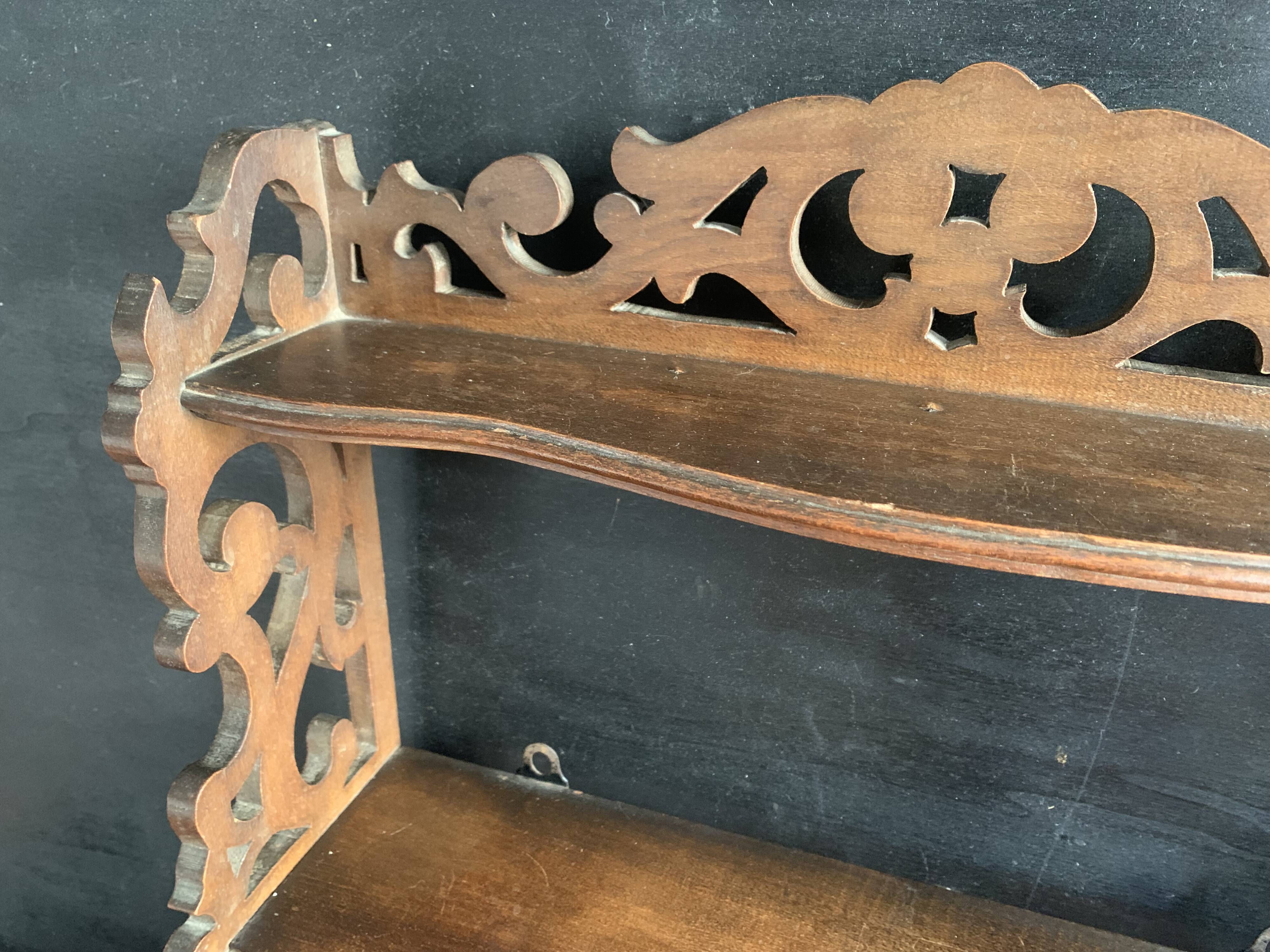 Antique shelf with openwork wooden pediment, early 20th century