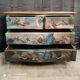 Patinated crossbow chest of drawers