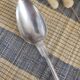 Large silver spoon with net decoration.
