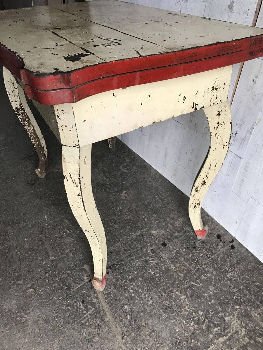 Rustic red and cream wooden dining table, moulded top, 1950s.