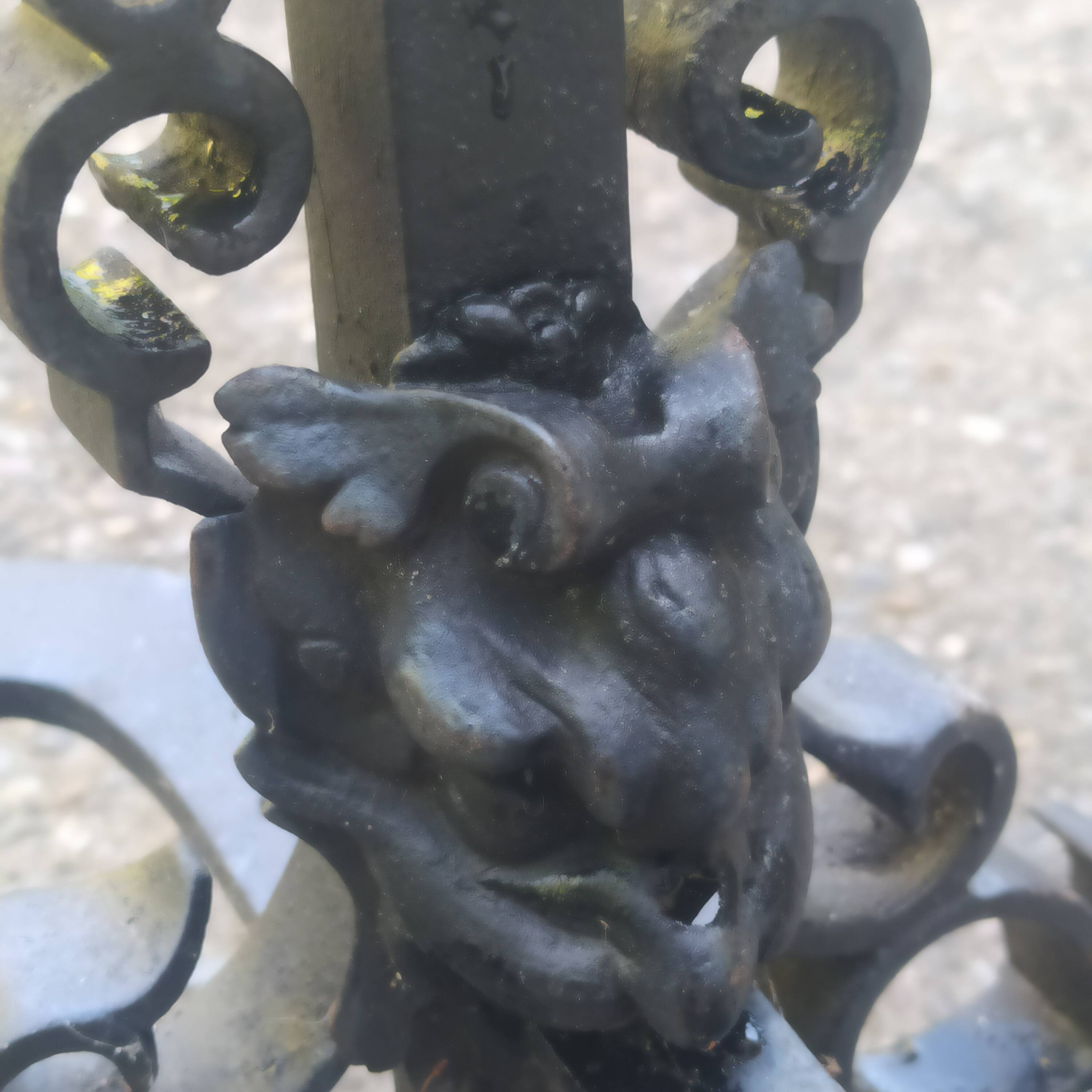 pair of large 20th century metal andirons with mascaron decoration