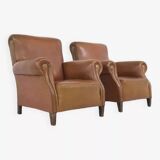 Pair of 1950s club armchairs in imitation leather and wood
